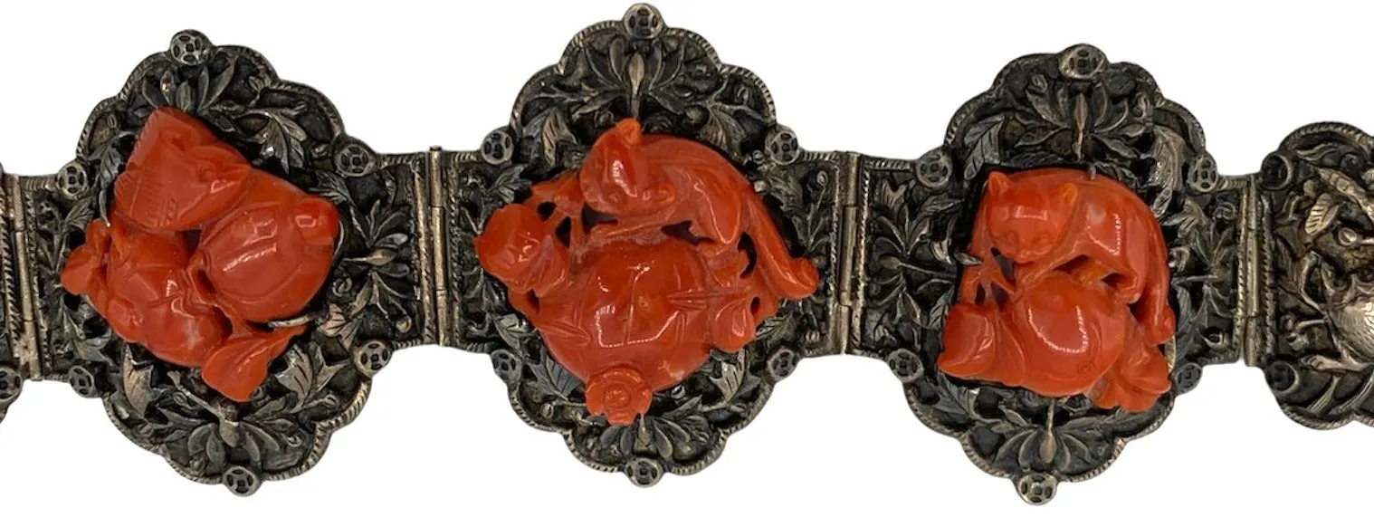 1920s Chinese Silver Repousse Bracelet with Deep Carved Coral Figuratives