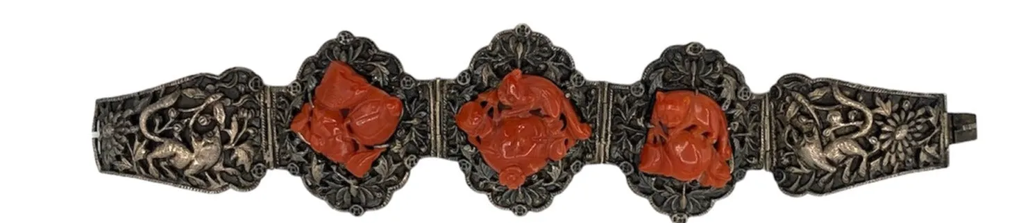 1920s Chinese Silver Repousse Bracelet with Deep Carved Coral Figuratives