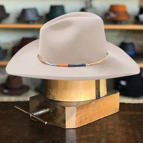 Classic White Cowboy Hat with Wide Crown and Downturned Brim